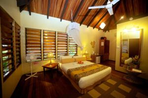 a bedroom with a large bed and a window at Club Fiji Resort in Nadi