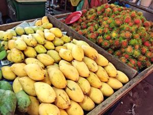 a display of fruits and vegetables in a market at Rio Monte Residence in Bangkok