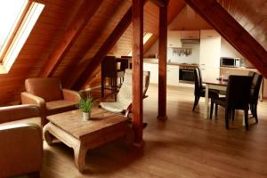 a living room and kitchen with a table and chairs at Stadthotel Jülich - Hotelwohnungen in Jülich