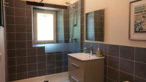 a bathroom with a sink and a mirror at Cottages de Garrigue in Fonroque +21 photos