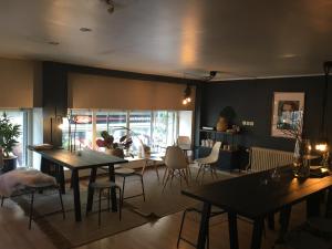 a living room with tables and chairs and a dining room at Morris Hotel in Örebro