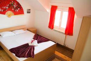 a small room with a bed and a window at Airport Apartments in Belgrade
