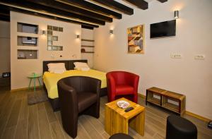 a room with a bed and a table and chairs at St. Stephen's Square Apartment in Hvar