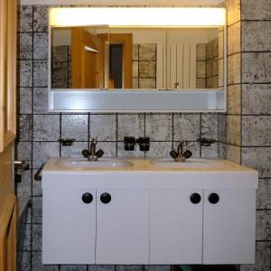 a bathroom with two sinks and a mirror at Haus Azalea in Davos +72 photos