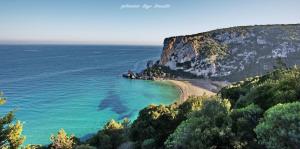 a view of a beach next to a cliff at B&B Santa Lucia in Dorgali