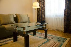 a living room with a couch and a glass table at Soluxe Hotel in Bishkek