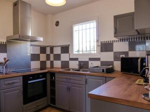 a kitchen with a sink and a stove top oven at vacances en bord de mer in Carqueiranne +3 photos