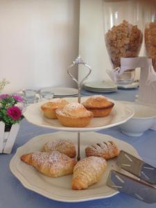 a table with three plates of pastries on them at Mirage B&B in Alezio