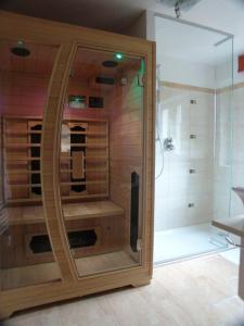 a bathroom with a shower with a glass door at Landhaus Alpensonne in Neustift im Stubaital +63 photos