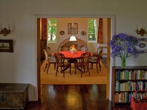a dining room with a table and chairs at Beautiful house on the garden island of Madeira in Santo da Serra