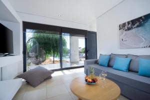 a living room with a couch and a table at Seametry Luxury Living Villa in Chania