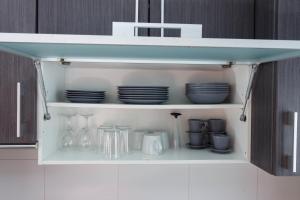 a cupboard with plates and dishes on it at Apartamentos Santa Barbara in Alicante
