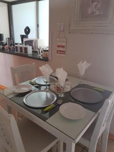 a table with plates and napkins on top of it at Woodpecker Guesthouse in Ficksburg