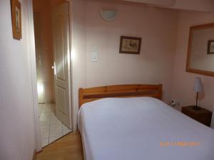 1 dormitorio con 1 cama blanca en una habitación en Gênois 1, en Hourtin