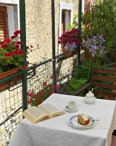 - une table avec un livre et un morceau de gâteau dans l'établissement afra Bed & Breakfast, à Castellabate