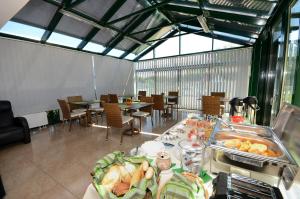 a dining room with a table with food on it at Szárszó Panzió in Balatonszárszó +75 photos