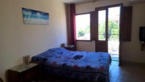 a bedroom with a blue bed and a window at B&B Neverland in Marrùbiu