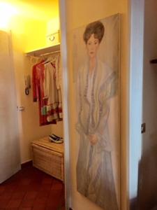 a painting of a woman on a closet door at B&B Volta in Como