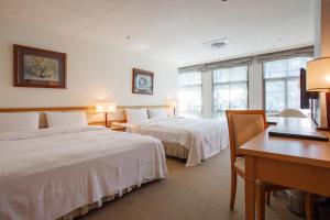 Ένα ή περισσότερα κρεβάτια σε δωμάτιο στο The Koos Hotel