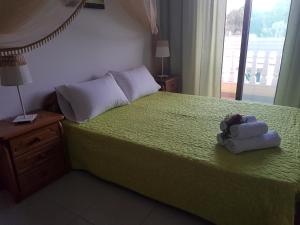 a bedroom with a green bed with a stuffed animal on it at Georgia Old Town Apartments in Rhodes Town