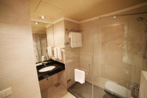 a bathroom with a sink and a glass shower at Princessa Hotel in Jounieh