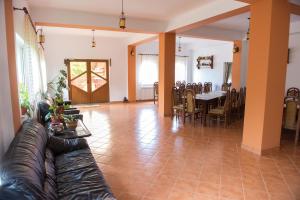 a living room with a couch and a table at Casa Andreea in Suceviţa