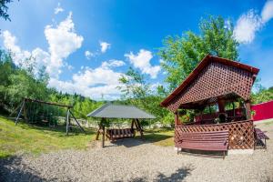a playground with a pavilion and a swing set at Casa Andreea in Suceviţa