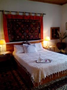 a bedroom with a bed with a plate on it at Nightingale Cottage Pelion in Kalamaki