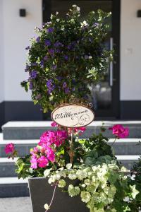 a planter filled with flowers in front of a door at Hotel Alpina in Galtür