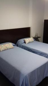 Postel nebo postele na pokoji v ubytování Apartamentos Turísticos Los Ángeles