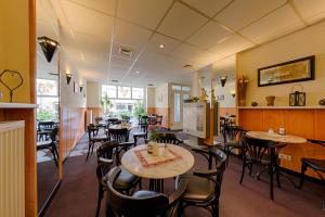 a restaurant with tables and chairs in a room at Hotel-Pension Lender in Bad Freienwalde