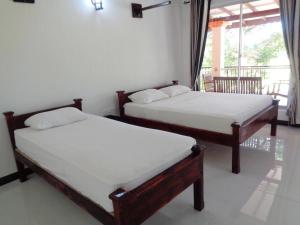 Katil atau katil-katil dalam bilik di Man Guest Polonnaruwa