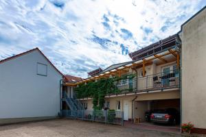 a building with a car parked in front of it at Hotel-Pension Lender in Bad Freienwalde