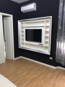 a living room with a tv on a black wall at Donna Margharet in Crotone