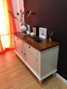a cabinet with a vase on top of it at Donna Margharet in Crotone