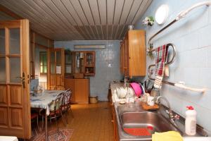 a kitchen with a sink and a table in it at Vila Pas Justiną in Palanga