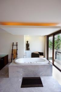 a large bath tub in a room with a large window at Boracay Beach Houses in Boracay