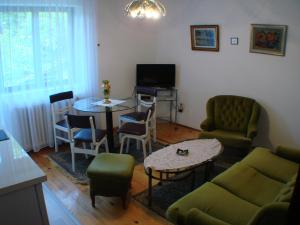 a living room with a couch and a table and chairs at Apartments M in Soko Banja
