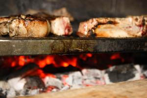 two pieces of meat are cooking in an oven at Villa Nymphea Water Lily in Hisarya
