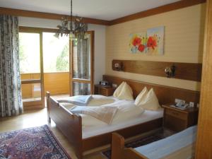 1 dormitorio con 1 cama en una habitación con ventana en Pension & Appartement Steinwender, en Bad Kleinkirchheim