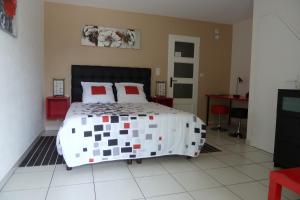 a bedroom with a large bed with white and red pillows at En Rouge et Noir in Monbazillac
