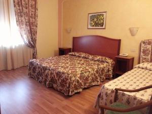 Postel nebo postele na pokoji v ubytování Hotel Minerva Palace