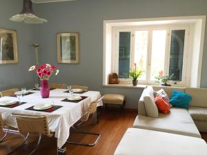 a dining room with a table and a couch at Casa Rinaldi in Poggio Mirteto