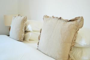 a pile of pillows sitting on top of a bed at Feeling Eduardo VII in Lisbon