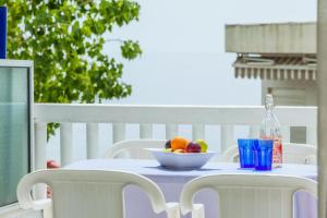 a bowl of fruit on a table on a balcony at Xenios Loutra Village Arsinoi Studios in Agia Paraskevi