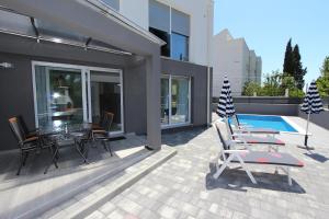 a patio with a table and chairs and a flag at Apartment Karlo 2 in Rovinj