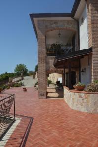 a brick patio with a balcony and a building at B&B Miracapri in Agropoli