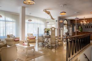 a living room with chairs and a table at Bella Colina I Vintage Hotel 1953 in Paguera