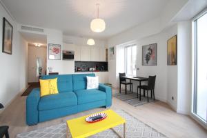 a living room with a blue couch and a table at Palais Foch in Cannes