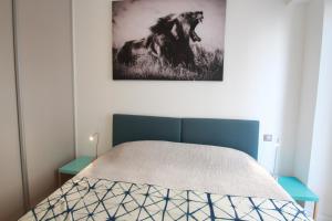 a bedroom with a bed with a picture of a horse on the wall at Palais Foch in Cannes